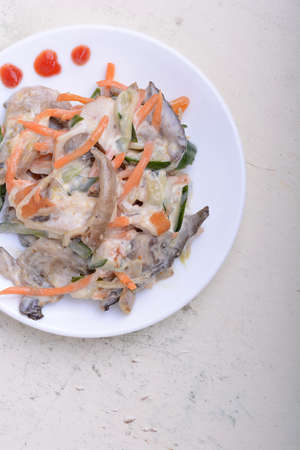 mushroom salad with champignon and fresh carrots, white plate on white plate with watercolorの写真素材