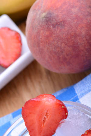 peach strawberry bananas mandarin close up as health food conceptの写真素材