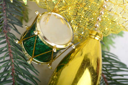 Christmas background with drums, green eve tree branch, golden new year decorationの写真素材