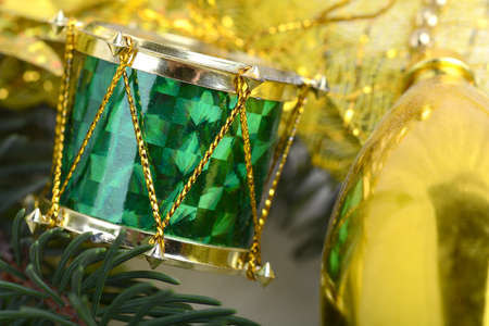 Christmas background with drums, green eve tree branch, golden new year decorationの写真素材