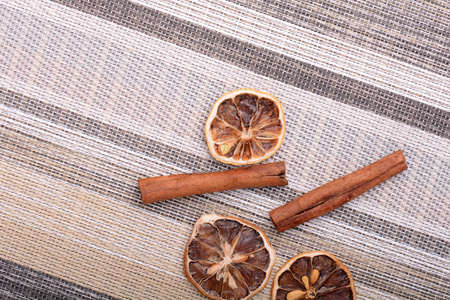 Slices of fresh dried lemon, orange and spices for cooking or bakingの写真素材