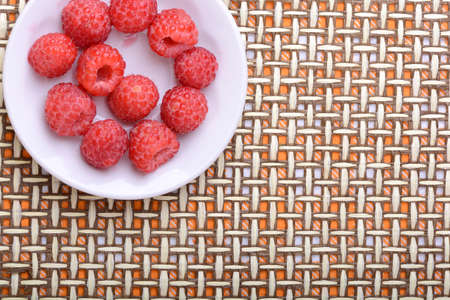 Big Pile of Fresh Raspberries in the White Bowlの写真素材