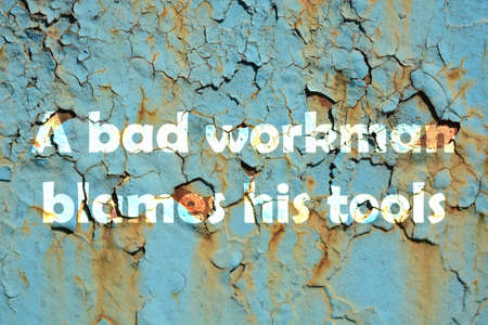A bad workman blames his tools. words print on the grunge metallic wallの写真素材