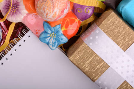 Arrangement of Gift Boxes in Wrapping Paper with Checkered Ribbons and Decorated Easter Eggs. White...
