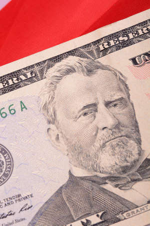 fifty dollar bill in front of the American flagの写真素材