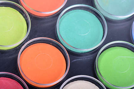 Paint pots in assorted colors. close up on wooden plateの写真素材