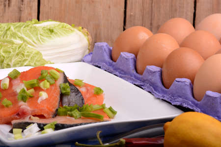fresh salmon fillet close up on white plate. eggs, cinnamon and lemonの写真素材