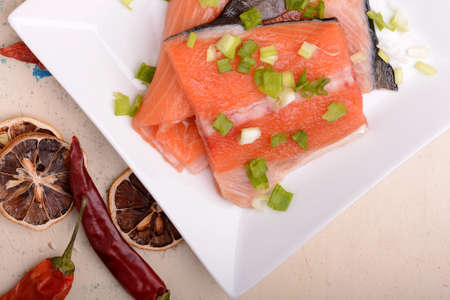 fresh salmon fillet close up on white plate. eggs, cinnamon and lemonの写真素材