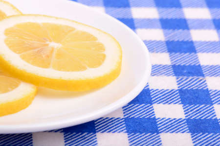 cut a lemon in an old white plateの写真素材