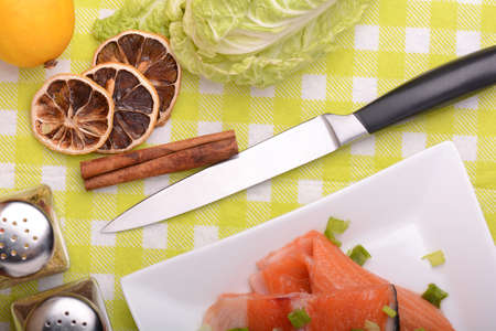 Food concept: red salmon fish, lemon and cabbage with red hot chilli pepper with greens. Healthy...