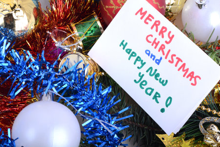 Merry Christmas and Happy New Year Holiday card. White paper and christmas greetings, balls set...