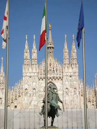 famous gothic cathedral in Milan in Italy. 3 flags-vatican,italian, european.    の写真素材