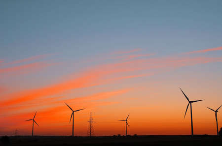 Wind electric power plant on sunset skyの写真素材