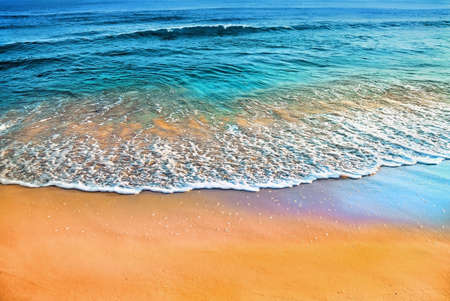 Colorfull seascape with sandy beach. A lot of reflexions in the water and wet sand.の写真素材
