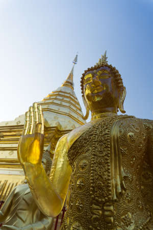 The Yellow Emerald buddha with Suthep pagoda behind. At Chiang Mai, Thailandの写真素材