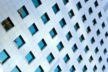 Modern office building windows with vertical lines and reflectionの写真素材