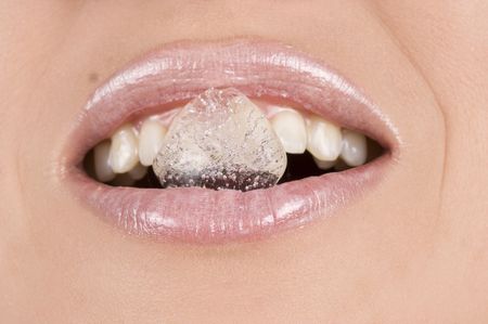 Close-up of beautiful woman with ice cubeの写真素材