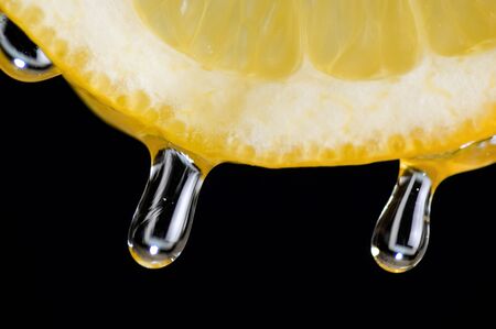 Drops of juice falling of the lemonの写真素材