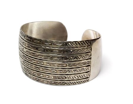 Ethnic silver bangle with handmade ornament isolated on whiteの写真素材