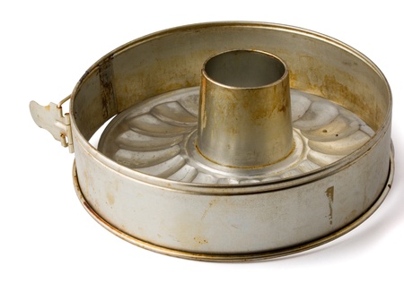 Old fluted tube baking pan isolated on white
