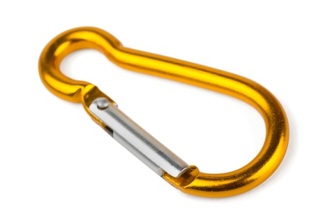 Single golden aluminium carabiner isolated on whiteの写真素材