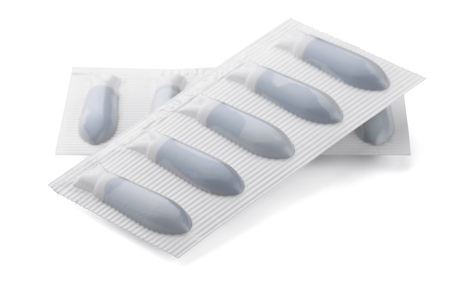 Two plastic packs of suppositories isolated on white