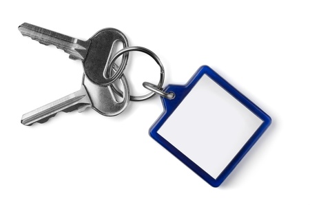 Two silver keys with blank key fob isolated on white