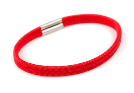 Red fabric-covered elastic hair scrunchy isolated on whiteの写真素材