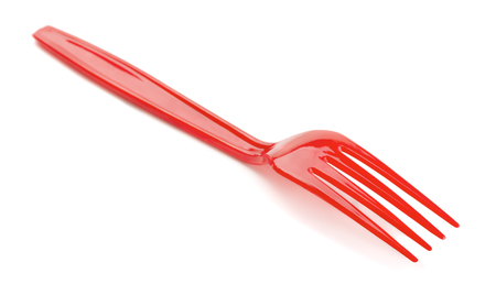 Red plastic fork isolated on whiteの写真素材