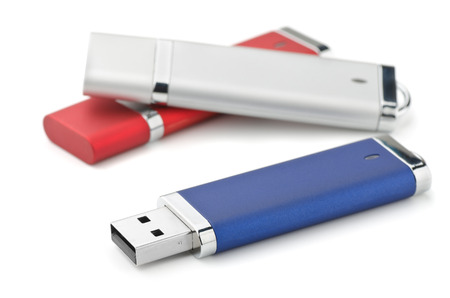 Three USB flash drives isolated on white
