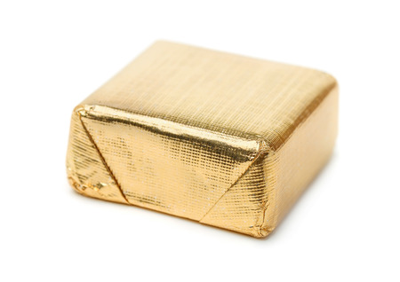 Foil wrapped chocolate candy isolated on whiteの写真素材