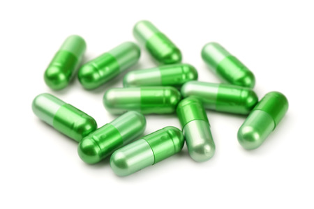 Green pills isolated on whiteの写真素材