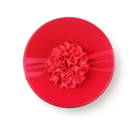Top view of round gift box with ribbon isolated on whiteの写真素材