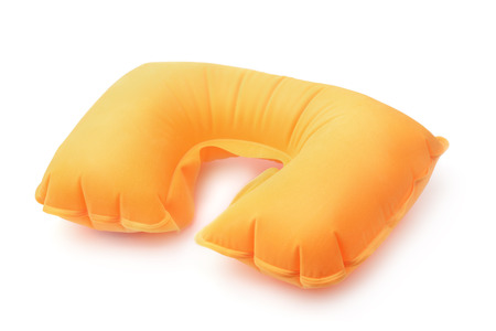 Orange inflatable neck pillow isolated on whiteの写真素材