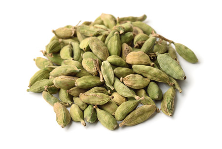 Heap of cardamom pods isolated on whiteの写真素材