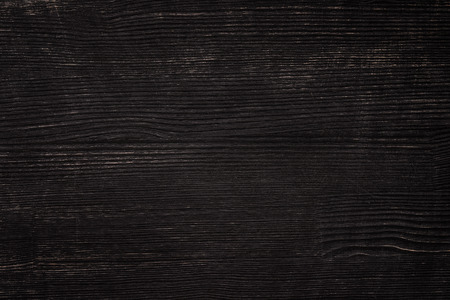 Old scratched black painted wooden board