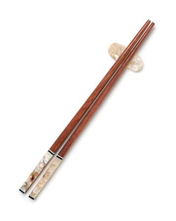 Top view of wooden chopsticks on chopstick rest isolated on whiteの写真素材