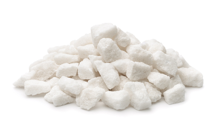 Pile of organic lump sugar isolated on whiteの写真素材