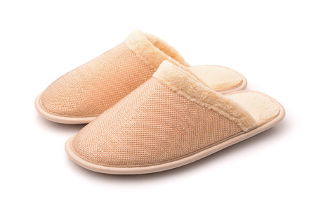Pair of soft yellow slippers isolated on whiteの写真素材