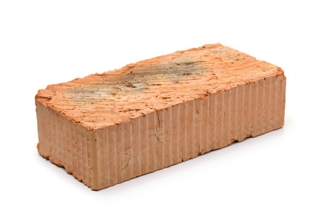 Single red clay rough brick isolated on whiteの写真素材