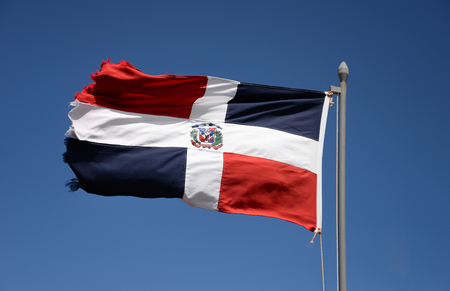 Dominican Republic flag waving against blue skyの写真素材