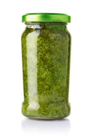 Glass jar of pesto sauce isolated on theの写真素材