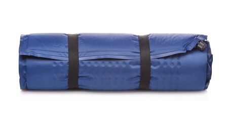 Front view of rolled blue self-inflating foam camping mattress isolated on white