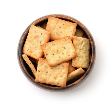 Top view of rosemary crackers in wooden bowl isolated on whiteの写真素材