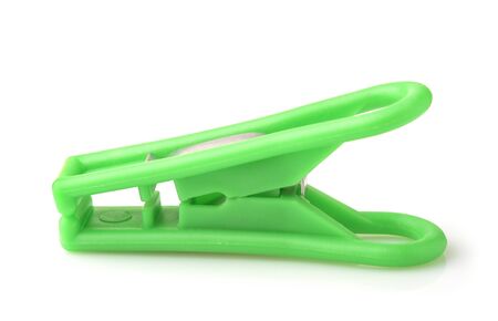 Side view of green plastic clothespin isolated on whiteの写真素材