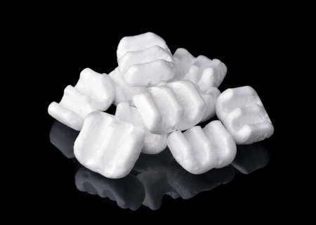 Group of m-shaped  packing chips isolated on blackの写真素材