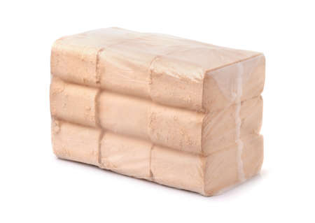 Packed organic pressed sawdust fuel briquettes isolated on whiteの写真素材
