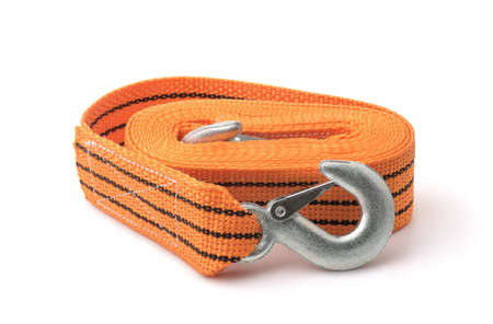 Rolled orange car tow rope with hooks isolated on white
