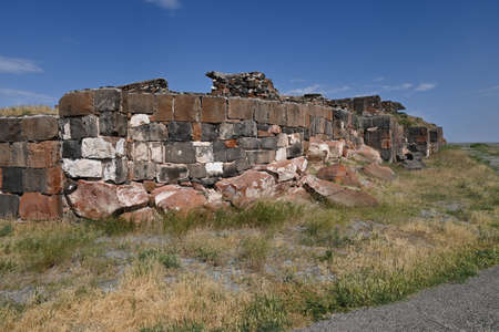 Ruined Fortress Erebuni walls made of tufa, Yerevan, Armenia on sunny summer day