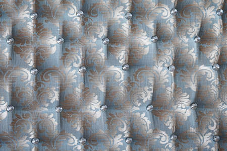 Front view of antique furniture upholstery with embroidery and crystal buttons textureの写真素材